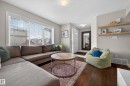 Living room featuring dark wood-style flooring and baseboards - 5256 21 Avenue, Edmonton, AB  - Indoor Photo Showing Living Room 