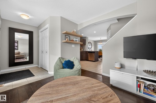 Entryway featuring dark wood-style floors and arched walkways - 5256 21 Avenue, Edmonton, AB - Indoor