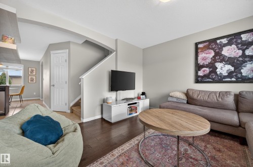 Living room with stairs and wood finished floors - 5256 21 Avenue, Edmonton, AB - Indoor Photo Showing Living Room