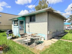 Exterior featuring stucco siding and a screened-in porch with wood steps - 