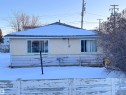 View of side of home featuring stucco and wood siding - 10407 102 Street, Westlock, AB  - Outdoor 