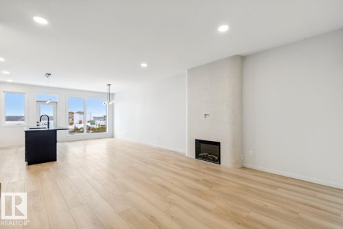 7471 Klapstein Crescent, Edmonton, AB - Indoor Photo Showing Other Room With Fireplace