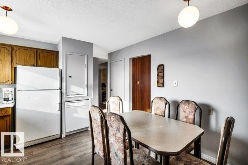 Dining space with dark wood-style floors and a textured ceiling - 8919 152A Avenue, Edmonton, AB - Indoor Photo Showing Dining Room