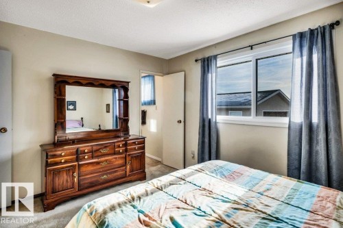 Bedroom with light carpet and a textured ceiling - 8919 152A Avenue, Edmonton, AB - Indoor Photo Showing Bedroom