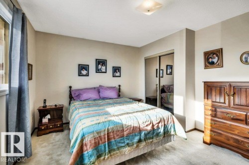 Carpeted bedroom featuring a closet and baseboards - 8919 152A Avenue, Edmonton, AB - Indoor Photo Showing Bedroom