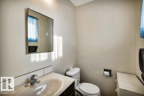Half bath with vanity and plenty of natural light - 8919 152A Avenue, Edmonton, AB - Indoor Photo Showing Bathroom