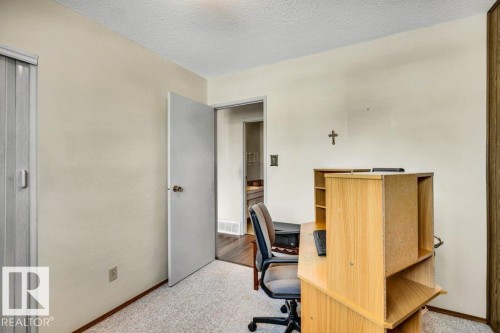 Office area with light colored carpet and a textured ceiling - 8919 152A Avenue, Edmonton, AB - Indoor