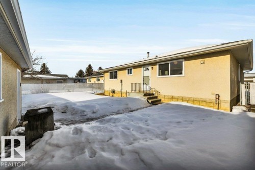 Snow covered rear of property featuring stucco siding - 8919 152A Avenue, Edmonton, AB - Outdoor