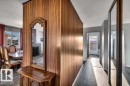 Corridor with a textured ceiling and dark wood-type flooring - 8919 152A Avenue, Edmonton, AB  - Indoor Photo Showing Other Room 