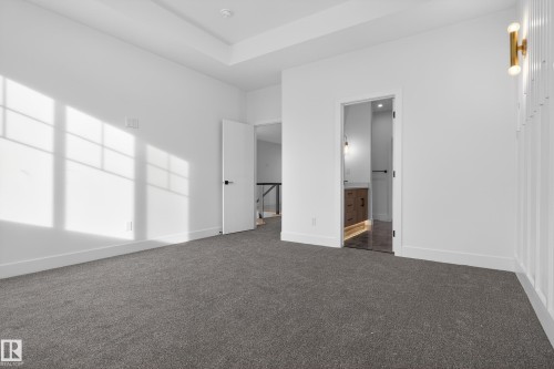Unfurnished bedroom with dark carpet and ensuite bath - 26 Rosa Crescent, St. Albert, AB - Indoor Photo Showing Other Room