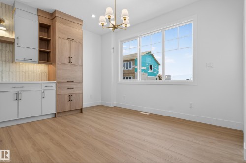 Unfurnished dining area featuring hanging lights and light wood-style flooring - 26 Rosa Crescent, St. Albert, AB - Indoor