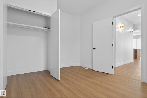 Unfurnished bedroom with light wood-style floors and baseboards - 26 Rosa Crescent, St. Albert, AB - Indoor Photo Showing Other Room