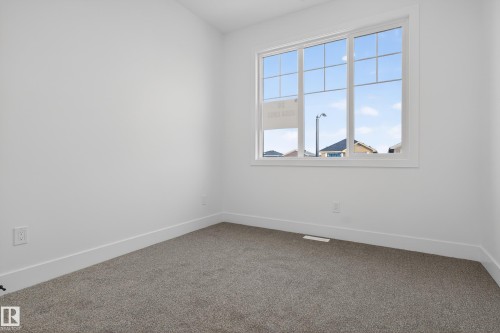 Carpeted empty room featuring baseboards - 26 Rosa Crescent, St. Albert, AB - Indoor Photo Showing Other Room