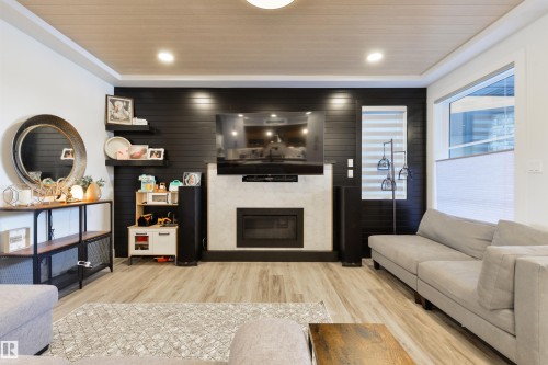 219 37 Street, Edmonton, AB - Indoor Photo Showing Living Room With Fireplace