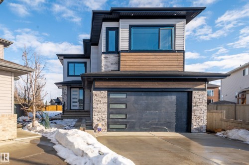 Modern home with stone siding, a garage, and concrete driveway - 16 Middleton Close, Leduc, AB - Outdoor With Facade