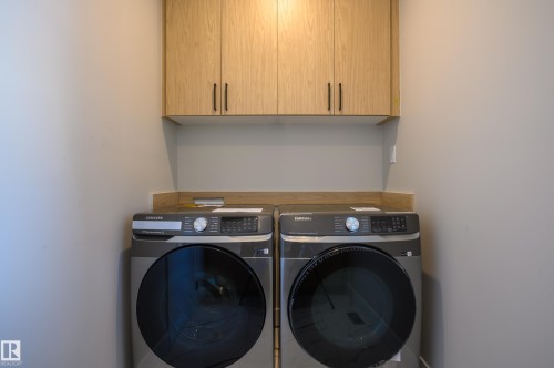 Laundry area with washer and clothes dryer and cabinet space - 16 Middleton Close, Leduc, AB - Indoor Photo Showing Laundry Room