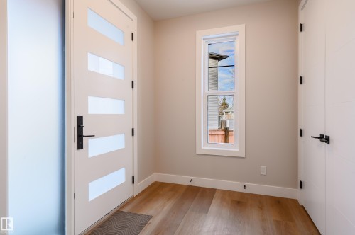 Doorway to outside featuring wood finished floors and baseboards - 16 Middleton Close, Leduc, AB - Indoor Photo Showing Other Room