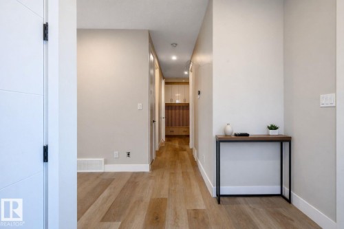 Hall with light wood-type flooring and baseboards - 16 Middleton Close, Leduc, AB - Indoor Photo Showing Other Room
