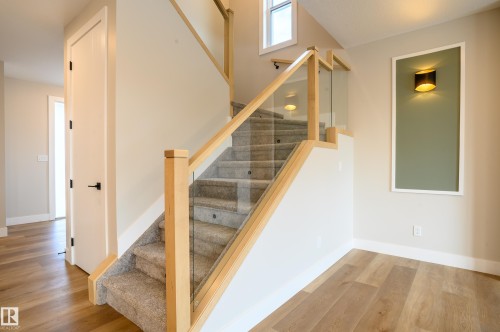 Staircase featuring baseboards and wood finished floors - 16 Middleton Close, Leduc, AB - Indoor Photo Showing Other Room