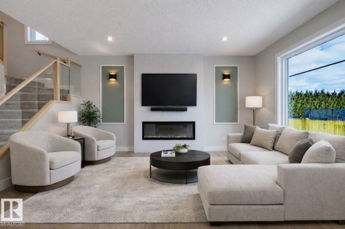 Living area with a glass covered fireplace, recessed lighting, wood finished floors, and a textured ceiling - 16 Middleton Close, Leduc, AB - Indoor Photo Showing Living Room With Fireplace