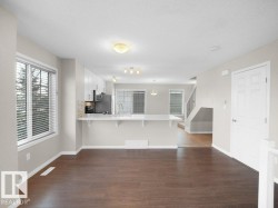 Unfurnished living room with dark wood-style flooring and a textured ceiling - 