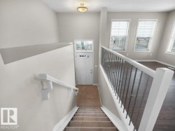 Stairway with baseboards and tile patterned floors - 