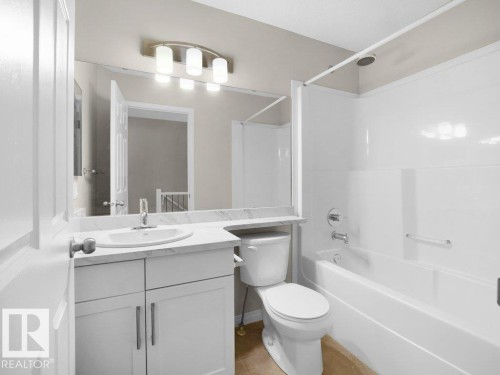 Full bathroom featuring vanity, bathtub / shower combination, and tile patterned floors - 15 7385 Edgemont Way, Edmonton, AB - Indoor Photo Showing Bathroom