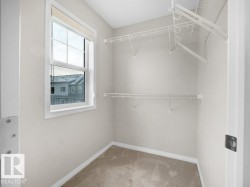 Walk in closet featuring light colored carpet - 