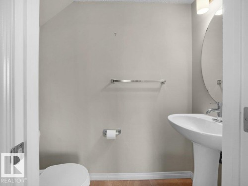 Half bathroom with baseboards and toilet - 15 7385 Edgemont Way, Edmonton, AB - Indoor Photo Showing Bathroom