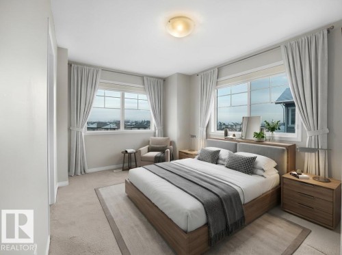 Bedroom featuring light colored carpet and baseboards - 15 7385 Edgemont Way, Edmonton, AB - Indoor Photo Showing Bedroom