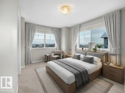 Bedroom featuring light colored carpet and baseboards - 