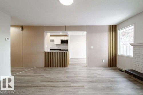 Unfurnished living room with light wood-type flooring - 13833 24 Street, Edmonton, AB - Indoor Photo Showing Kitchen