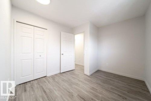 Unfurnished bedroom featuring light wood-type flooring and a closet - 13833 24 Street, Edmonton, AB - Indoor Photo Showing Other Room