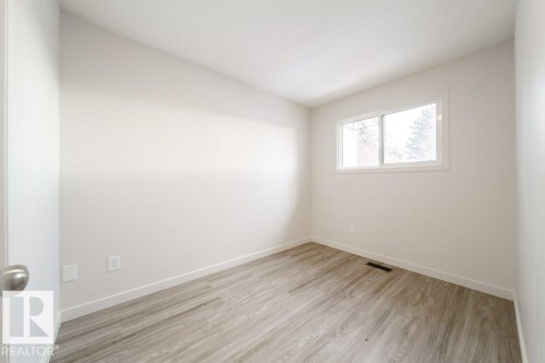 Spare room featuring light wood-style floors and baseboards - 13833 24 Street, Edmonton, AB - Indoor Photo Showing Other Room