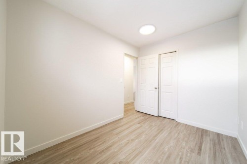 Unfurnished bedroom featuring light wood finished floors and a closet - 13833 24 Street, Edmonton, AB - Indoor Photo Showing Other Room