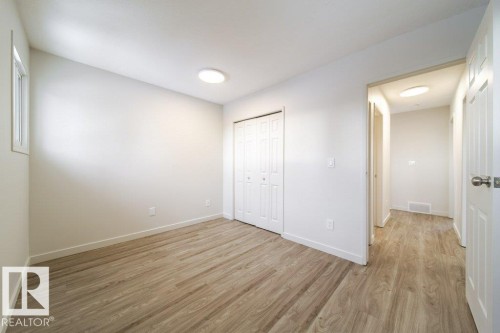 Unfurnished bedroom with light wood-type flooring and a closet - 13833 24 Street, Edmonton, AB - Indoor Photo Showing Other Room