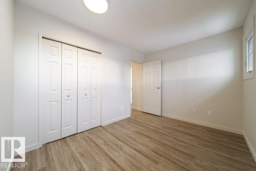 Unfurnished bedroom featuring light wood-type flooring and a closet - 13833 24 Street, Edmonton, AB - Indoor Photo Showing Other Room