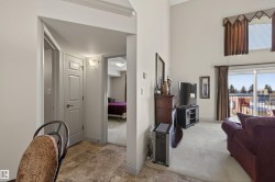 Hall with light carpet and stone finish floors - 