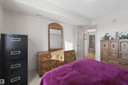 Bedroom featuring baseboards and light carpet - 