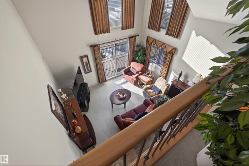 Carpeted living room with a high ceiling - 427 13005 140 Avenue, Edmonton, AB - Indoor Photo Showing Other Room