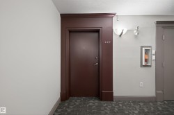 Hall featuring baseboards and a textured ceiling - 
