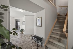Staircase featuring baseboards and stone finish flooring - 