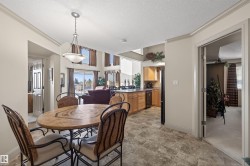 Dining area featuring a textured ceiling, ornamental molding, and stone finish floors - 