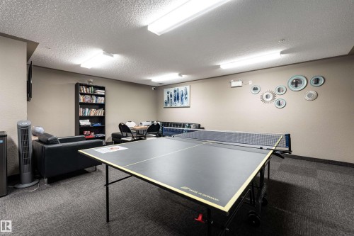 Rec room with carpet flooring, a textured ceiling, and a textured wall - 325 1520 Hammond Gate, Edmonton, AB - Indoor