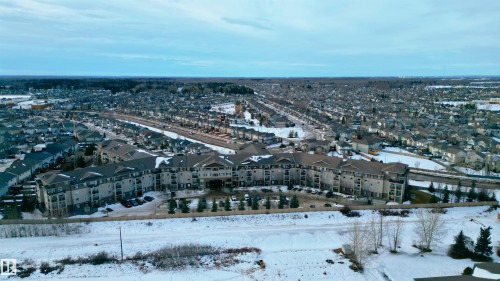 Snowy aerial view featuring a residential view - 325 1520 Hammond Gate, Edmonton, AB - Outdoor With View
