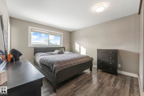 Bedroom featuring dark wood finished floors and baseboards - 14924 81 Street, Edmonton, AB 
