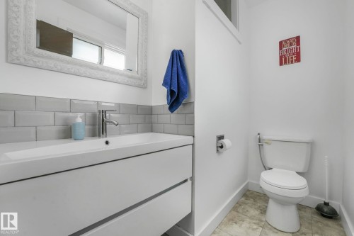 Half bathroom with vanity and light tile patterned floors - 14924 81 Street, Edmonton, AB 