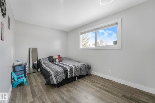 Bedroom with wood finished floors and baseboards - 14924 81 Street, Edmonton, AB 