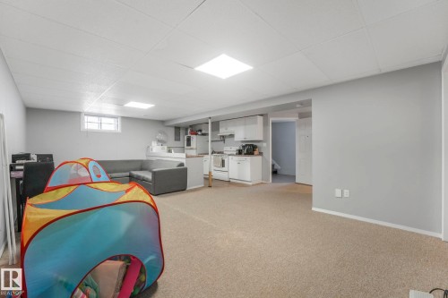 Playroom featuring light colored carpet and a drop ceiling - 14924 81 Street, Edmonton, AB 