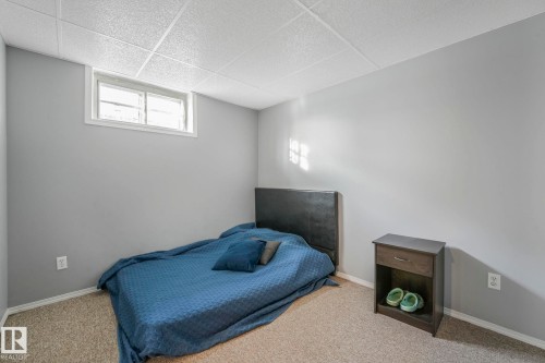 Carpeted bedroom with baseboards and a paneled ceiling - 14924 81 Street, Edmonton, AB 
